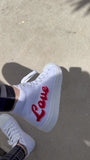 Girl Power Love high-top canvas shoes worn by our founder