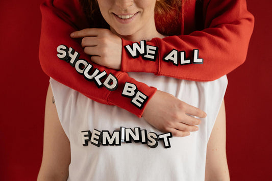 Close-up of feminist slogan t‑shirt with bold text on red background