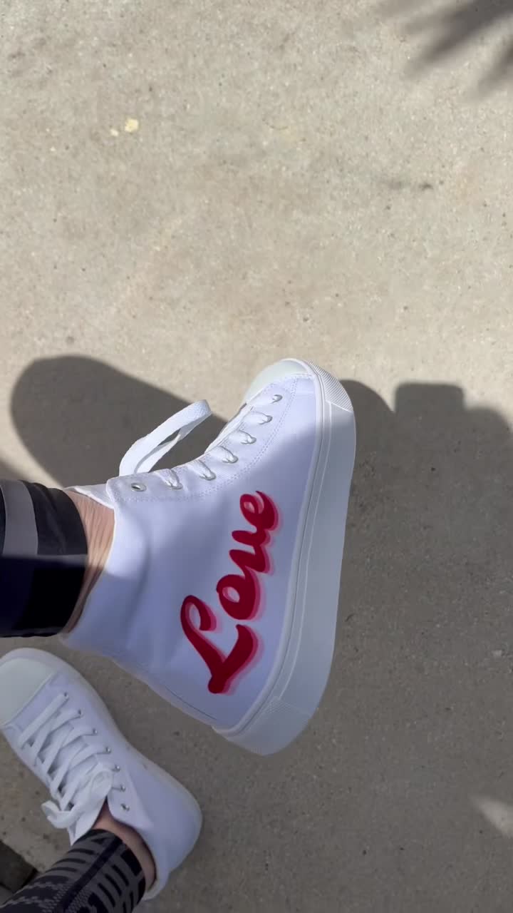 Girl Power Love high-top canvas shoes worn by our founder